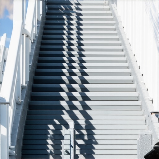 Close-up of outdoor stairs with composite treads and stainless steel fasteners.